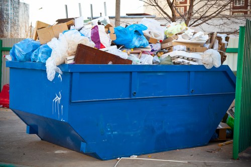 Resident disposing of old furniture at a Heston recycling center